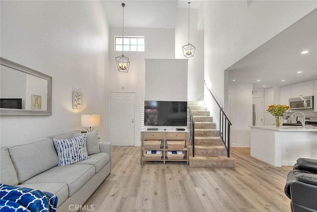2693 Lookout Cir, Chino Hills, CA 91709 - living area featuring a high ceiling, light wood-style flooring, stairway, and recessed lighting