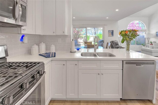 2693 Lookout Cir, Chino Hills, CA 91709 - kitchen featuring stainless steel appliances, a sink, a peninsula, white cabinetry, and open floor plan