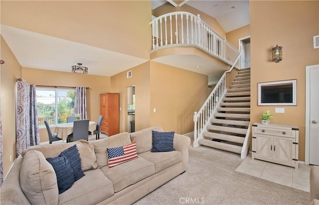 22447 Poplar St, Saugus, CA 91390 - living area featuring light colored carpet, stairway, and a towering ceiling