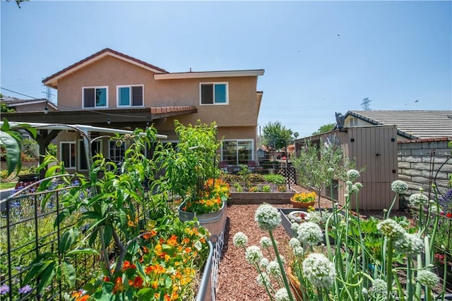 22447 Poplar St, Saugus, CA 91390 - rear view of property with a garden and stucco siding