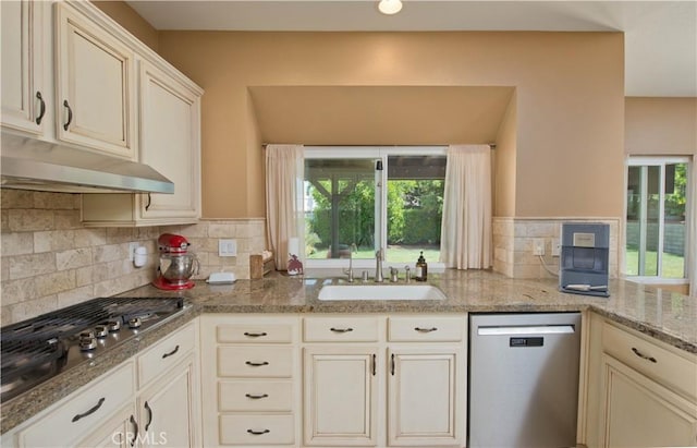 22447 Poplar St, Saugus, CA 91390 - kitchen with stainless steel appliances, a sink, under cabinet range hood, decorative backsplash, and light stone countertops