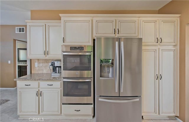 22447 Poplar St, Saugus, CA 91390 - kitchen featuring appliances with stainless steel finishes, light stone counters, decorative backsplash, and baseboards