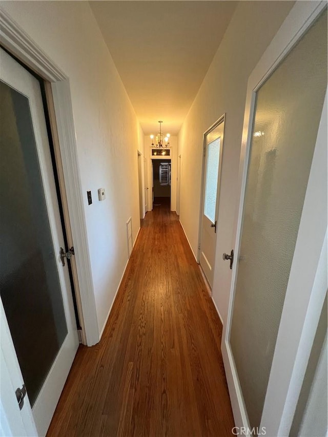 1465 N Euclid Ave, Upland, CA 91786 - hallway featuring a chandelier, wood finished floors, and baseboards