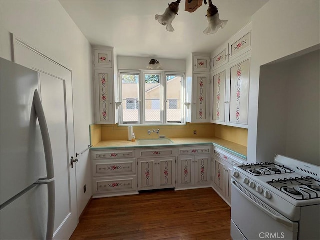 1465 N Euclid Ave, Upland, CA 91786 - kitchen with freestanding refrigerator, white range with gas cooktop, a sink, light countertops, and dark wood-type flooring