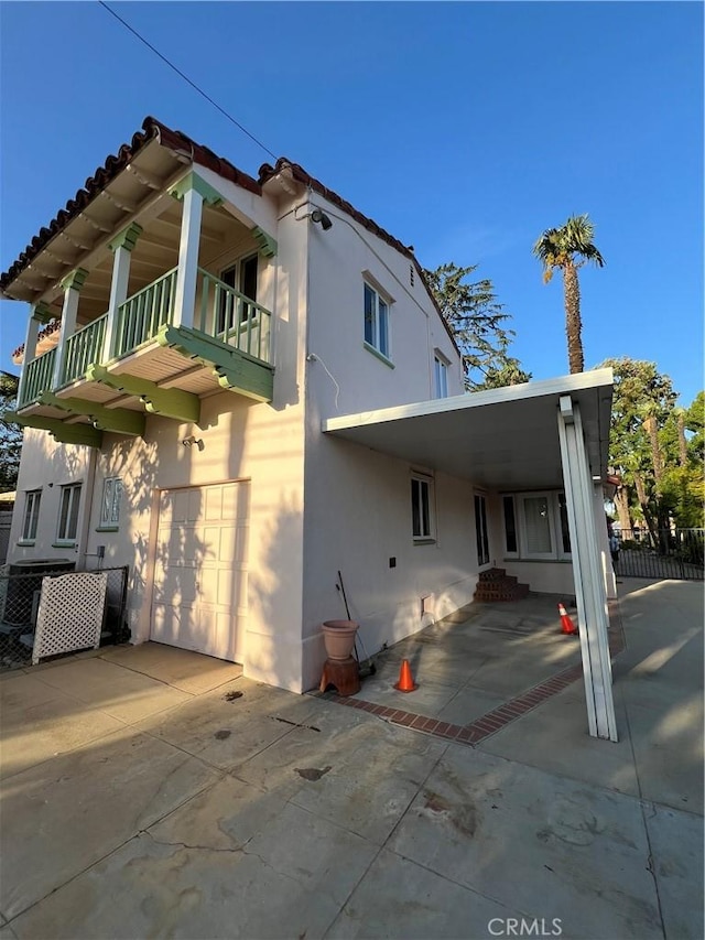 1465 N Euclid Ave, Upland, CA 91786 - view of home's exterior with a balcony, stucco siding, concrete driveway, and an attached garage