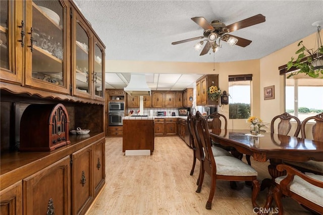3298 N Zediker Ave, Sanger, CA 93657 - dining room featuring light wood-type flooring, a ceiling fan, and a textured ceiling