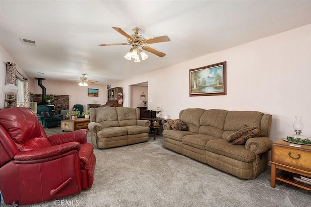 3298 N Zediker Ave, Sanger, CA 93657 - carpeted living room featuring a wood stove and ceiling fan