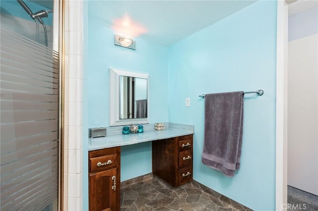 3298 N Zediker Ave, Sanger, CA 93657 - bathroom featuring vanity, stone finish floors, and a shower