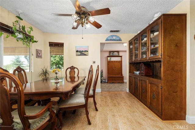 3298 N Zediker Ave, Sanger, CA 93657 - dining space featuring a textured ceiling, ceiling fan, light wood-type flooring, and baseboards