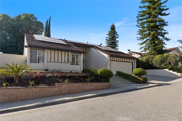 1319 Via Esperanza, San Dimas, CA 91773 - ranch-style house with an attached garage, roof mounted solar panels, board and batten siding, and concrete driveway