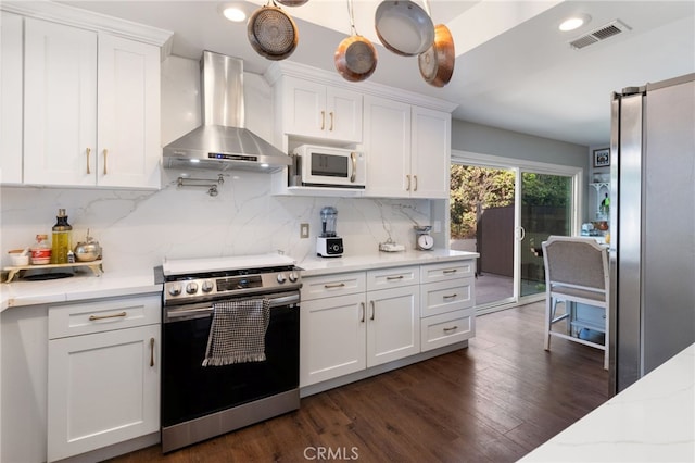 1319 Via Esperanza, San Dimas, CA 91773 - kitchen featuring stainless steel appliances, wall chimney exhaust hood, white cabinets, decorative backsplash, and recessed lighting