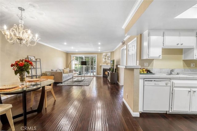 1535 S Bentley Ave Unit 202, Los Angeles, CA 90025 - kitchen featuring white dishwasher, ornamental molding, tile counters, a warm lit fireplace, and white cabinets