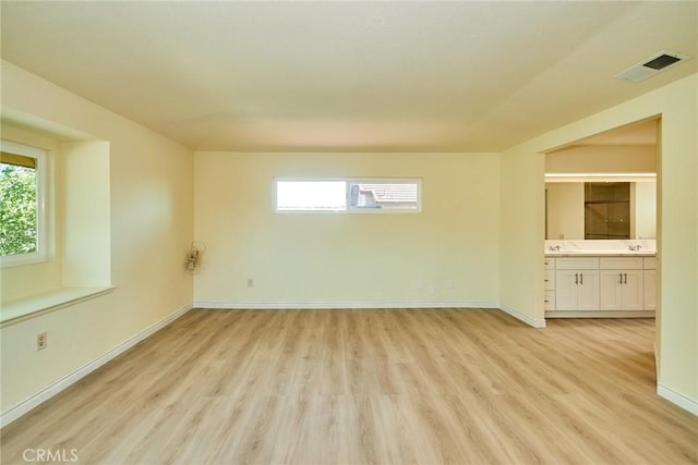 13855 Calada Dr, Moreno Valley, CA 92553 - unfurnished room featuring light wood-style floors, baseboards, and a sink