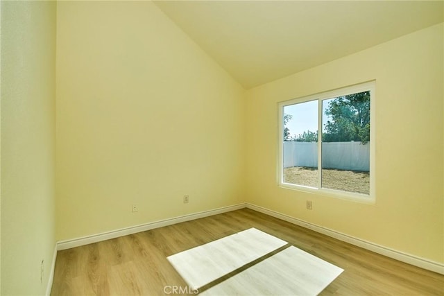 13855 Calada Dr, Moreno Valley, CA 92553 - unfurnished room with wood finished floors, vaulted ceiling, and baseboards