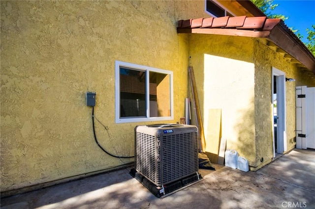 13855 Calada Dr, Moreno Valley, CA 92553 - view of home's exterior with central AC, stucco siding, and a patio area