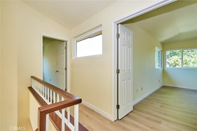 13855 Calada Dr, Moreno Valley, CA 92553 - corridor featuring vaulted ceiling, light wood-style floors, baseboards, and an upstairs landing