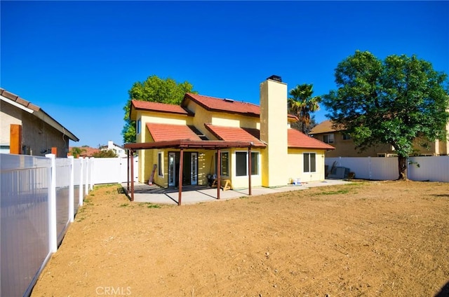 13855 Calada Dr, Moreno Valley, CA 92553 - rear view of property with a patio, a chimney, a fenced backyard, and stucco siding