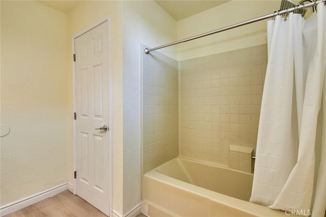 13855 Calada Dr, Moreno Valley, CA 92553 - full bathroom featuring baseboards, shower / bath combo with shower curtain, and wood finished floors