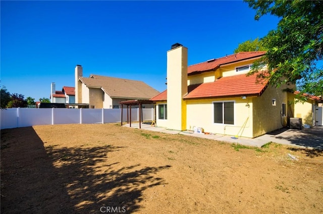13855 Calada Dr, Moreno Valley, CA 92553 - rear view of property featuring a patio area, a fenced backyard, stucco siding, a chimney, and cooling unit