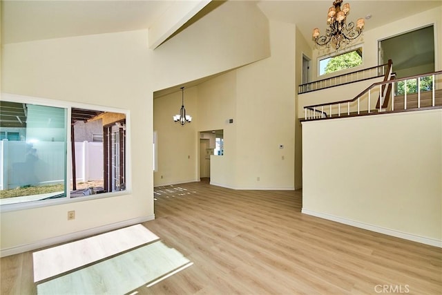 13855 Calada Dr, Moreno Valley, CA 92553 - unfurnished room with a chandelier, wood finished floors, baseboards, high vaulted ceiling, and beamed ceiling
