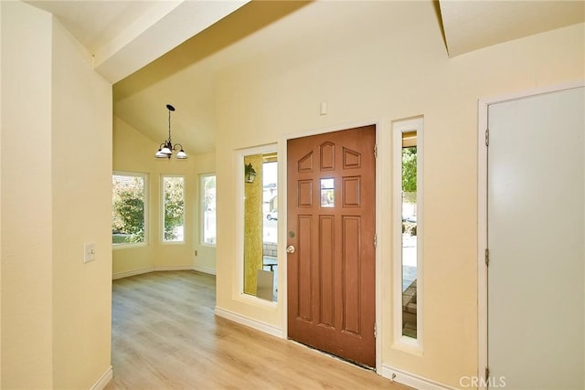 13855 Calada Dr, Moreno Valley, CA 92553 - entryway with light wood finished floors, a chandelier, baseboards, and high vaulted ceiling