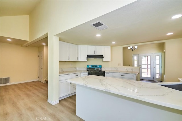 13855 Calada Dr, Moreno Valley, CA 92553 - kitchen with black range with gas stovetop, light wood-type flooring, white cabinetry, under cabinet range hood, and recessed lighting