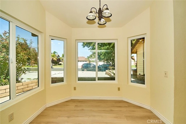 13855 Calada Dr, Moreno Valley, CA 92553 - unfurnished sunroom with a chandelier, wood finished floors, and baseboards
