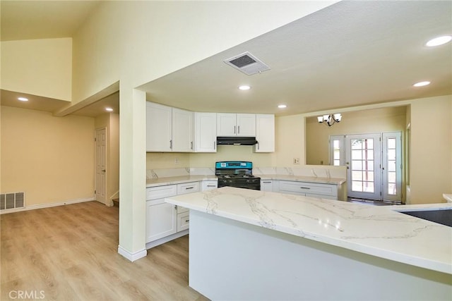 13855 Calada Dr, Moreno Valley, CA 92553 - kitchen featuring black range with gas stovetop, light wood-style floors, white cabinetry, under cabinet range hood, and recessed lighting