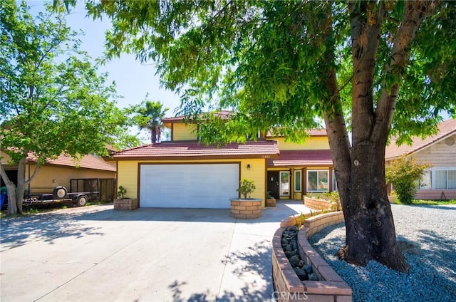 13855 Calada Dr, Moreno Valley, CA 92553 - view of front facade with driveway and a tile roof