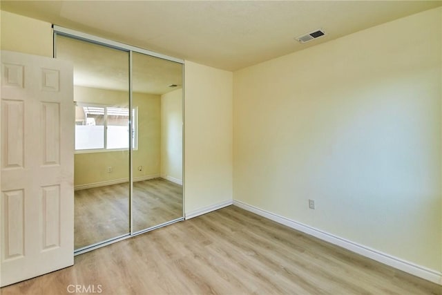 13855 Calada Dr, Moreno Valley, CA 92553 - unfurnished bedroom with wood finished floors, a closet, and baseboards