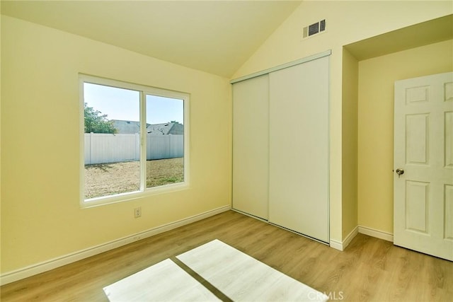 13855 Calada Dr, Moreno Valley, CA 92553 - unfurnished bedroom with wood finished floors, a closet, baseboards, and vaulted ceiling