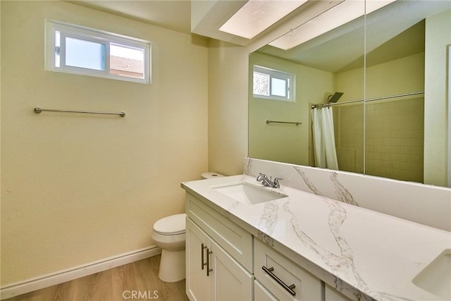 13855 Calada Dr, Moreno Valley, CA 92553 - full bath with toilet, baseboards, wood finished floors, vanity, and curtained shower