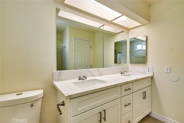 13855 Calada Dr, Moreno Valley, CA 92553 - bathroom with double vanity, toilet, and a textured wall