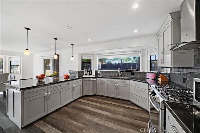 28636 Via Piedra, Valley Center, CA 92082 - kitchen featuring appliances with stainless steel finishes, wall chimney exhaust hood, a sink, dark wood-style floors, and a peninsula