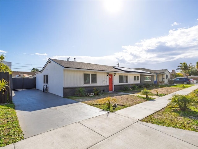 5518 W 117th St, Hawthorne, CA 90304 - ranch-style home with concrete driveway, brick siding, and solar panels