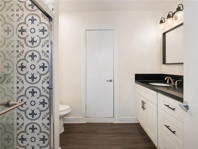 5518 W 117th St, Hawthorne, CA 90304 - bathroom featuring toilet, wood finished floors, vanity, and baseboards