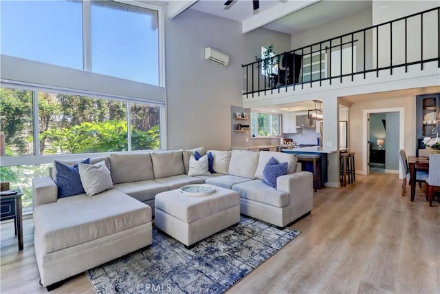259 Calle Aragon Unit A, Laguna Woods, CA 92637 - living area featuring a towering ceiling, light wood-style floors, plenty of natural light, ceiling fan, and an AC wall unit