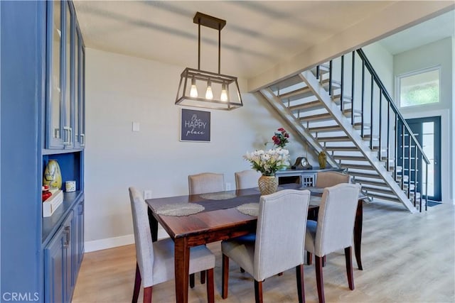259 Calle Aragon Unit A, Laguna Woods, CA 92637 - dining space featuring light wood-type flooring, stairway, and baseboards