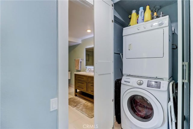 259 Calle Aragon Unit A, Laguna Woods, CA 92637 - washroom featuring stacked washer and clothes dryer and light tile patterned flooring