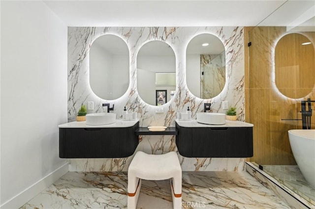 4816 Saint Andrews Ave, Buena Park, CA 90621 - full bathroom featuring marble tiled floors, two vanities, a soaking tub, baseboards, and stone wall