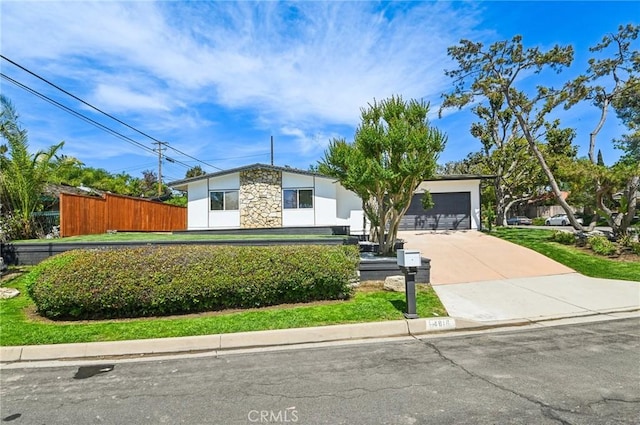 4816 Saint Andrews Ave, Buena Park, CA 90621 - mid-century modern home with a garage, driveway, and stone siding