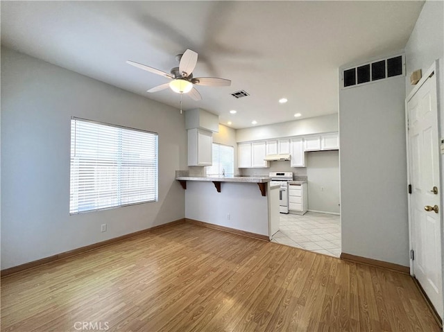 1729 Sunflower Ave Unit A, Glendora, CA 91740 - kitchen featuring a peninsula, a ceiling fan, a kitchen breakfast bar, white cabinetry, and white range oven