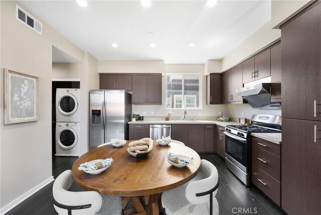 168 N Orange Ave, Brea, CA 92821 - kitchen with stainless steel appliances, stacked washer / dryer, dark brown cabinets, a sink, and light countertops