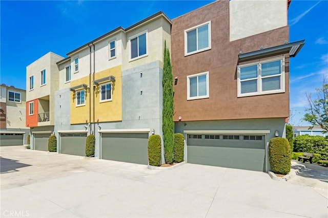 168 N Orange Ave, Brea, CA 92821 - rear view of property featuring a garage, stucco siding, and driveway