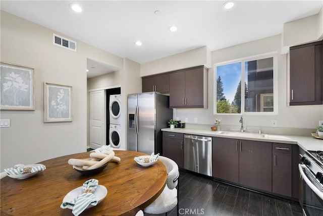 168 N Orange Ave, Brea, CA 92821 - kitchen with stainless steel appliances, stacked washer and clothes dryer, a sink, dark brown cabinets, and light countertops