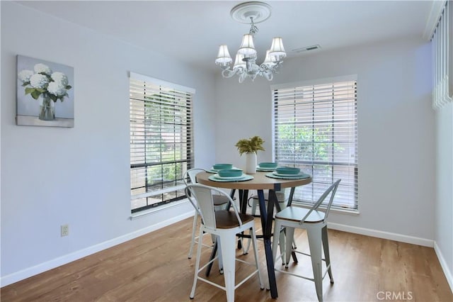 5303 State Highway 49 N Unit 14, Mariposa, CA 95338 - dining area featuring a chandelier, baseboards, and wood finished floors