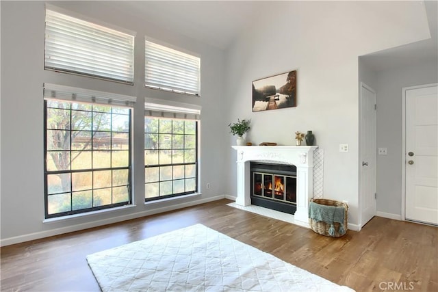 5303 State Highway 49 N Unit 14, Mariposa, CA 95338 - living room with wood finished floors, a fireplace with flush hearth, high vaulted ceiling, and baseboards