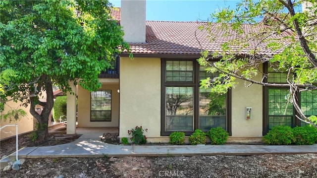 5303 State Highway 49 N Unit 14, Mariposa, CA 95338 - view of property exterior with stucco siding, a tiled roof, and a chimney