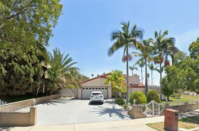 13150 Stern Ave, La Mirada, CA 90638 - view of front facade with driveway and stucco siding