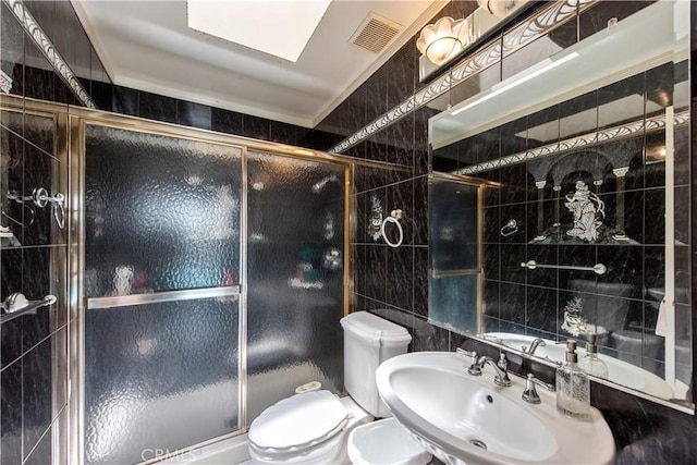 13150 Stern Ave, La Mirada, CA 90638 - full bathroom featuring toilet, a sink, tile walls, and a stall shower